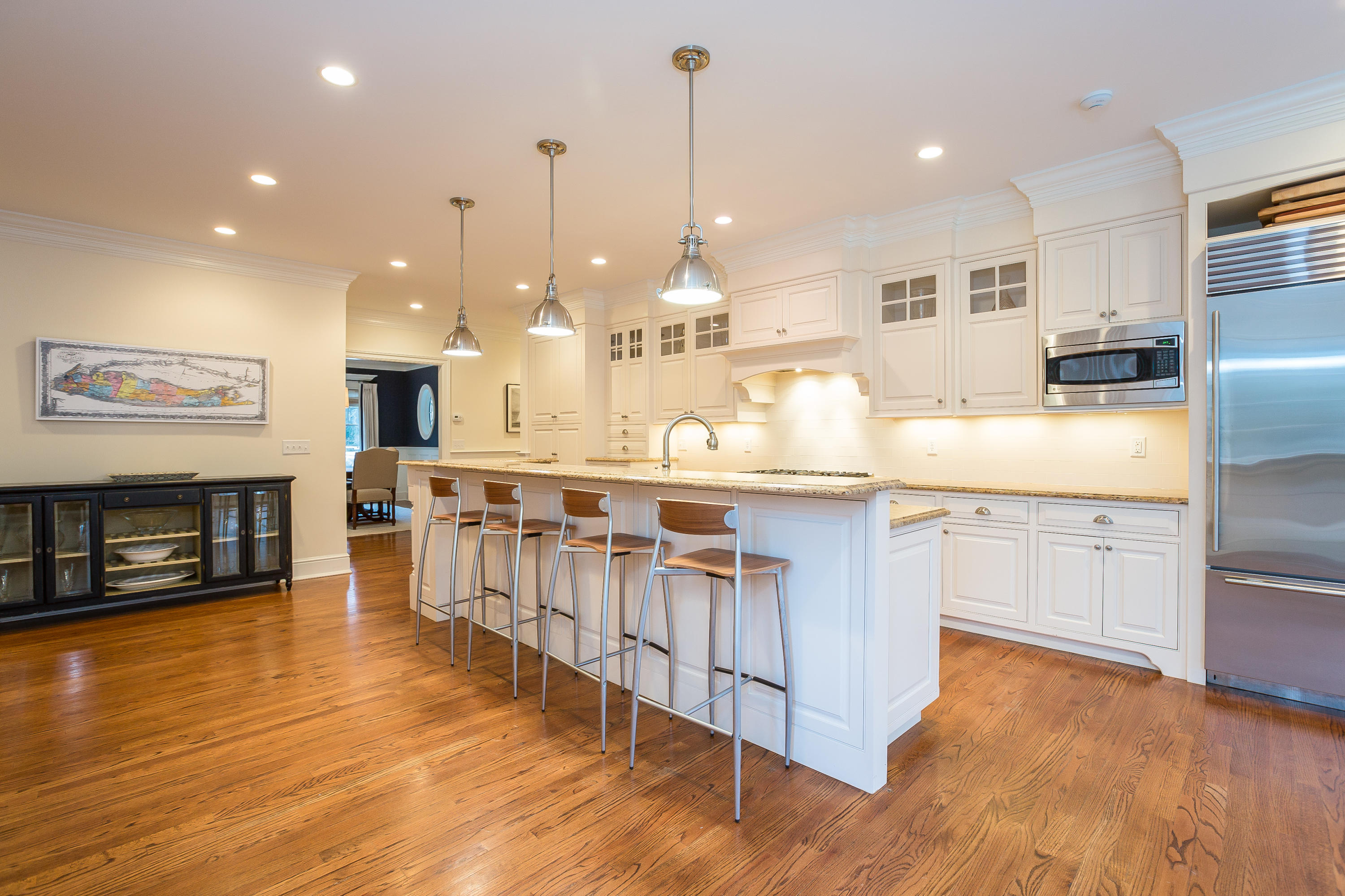 305 Middlesex Road Darien, CT 06820 - Photo 4 of 35 a kitchen with stainless steel appliances granite countertop a stove a sink a refrigerator a center island and wooden floor