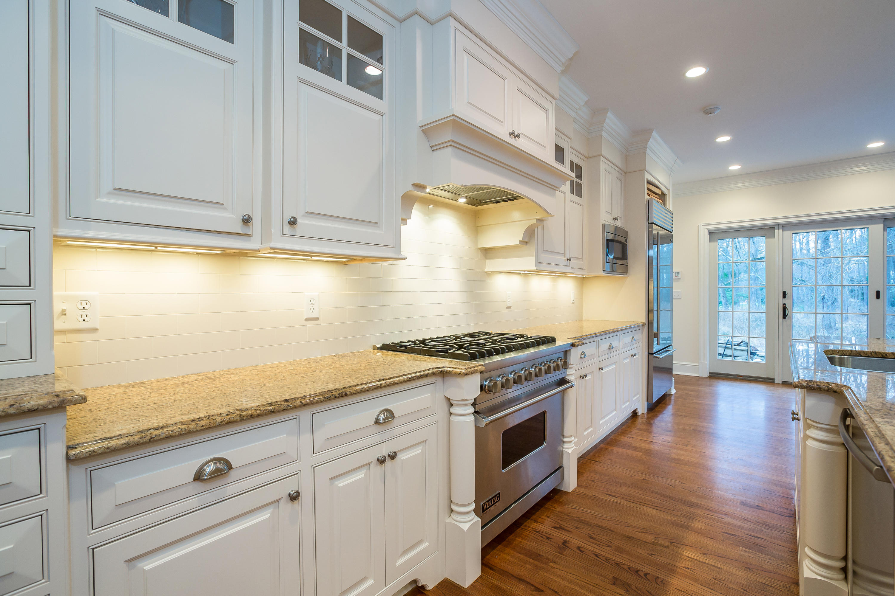 305 Middlesex Road Darien, CT 06820 - Photo 8 of 35 a kitchen with stainless steel appliances granite countertop a stove a sink and white cabinets