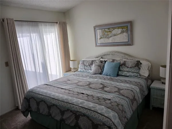 a kitchen with a refrigerator and a dining table