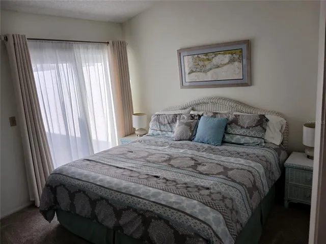 a kitchen with a refrigerator and a dining table