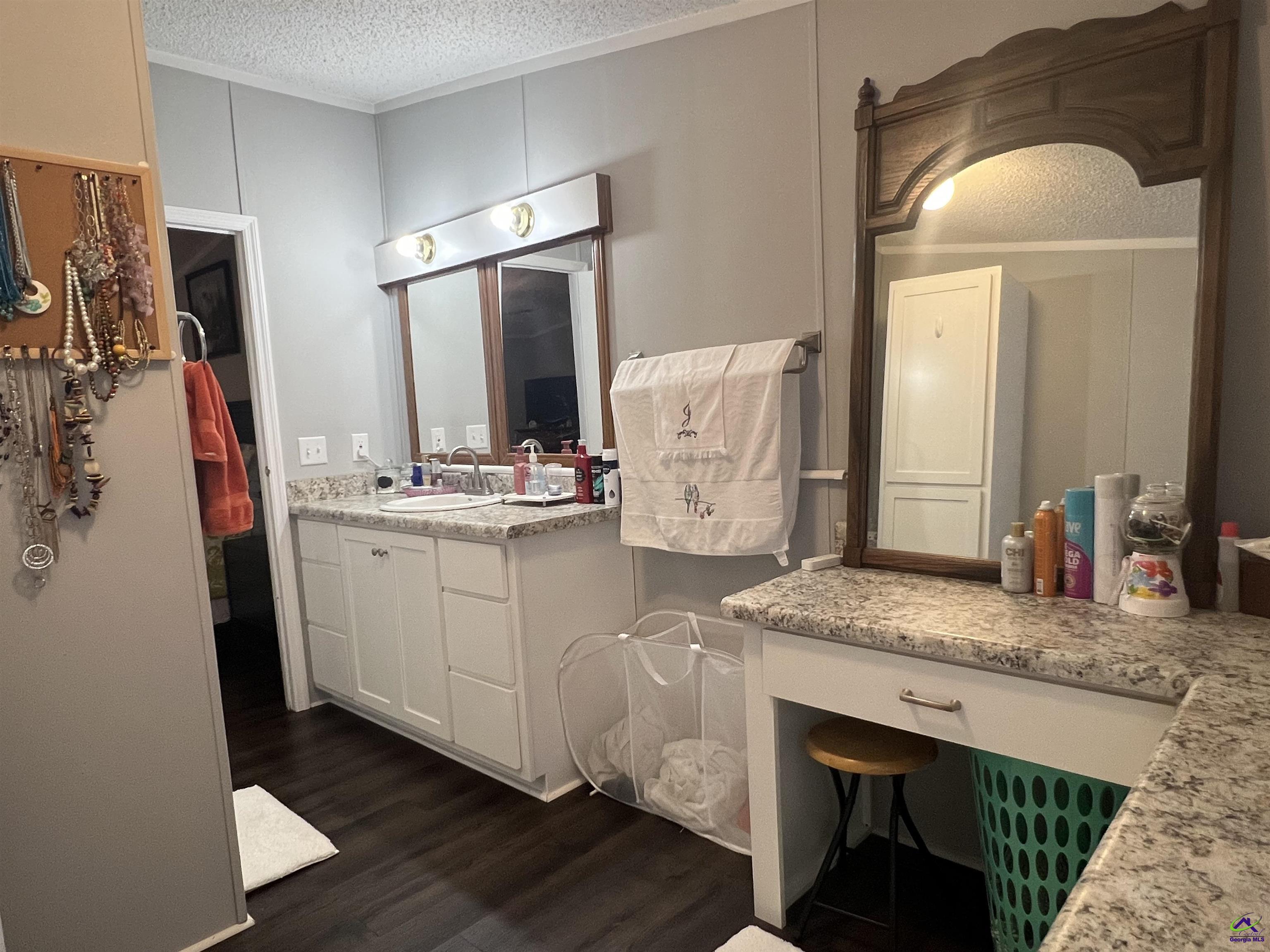 166 Pebble Hills Road Cochran, GA 31014 - Photo 22 of 27 a bathroom with a granite countertop sink and a mirror