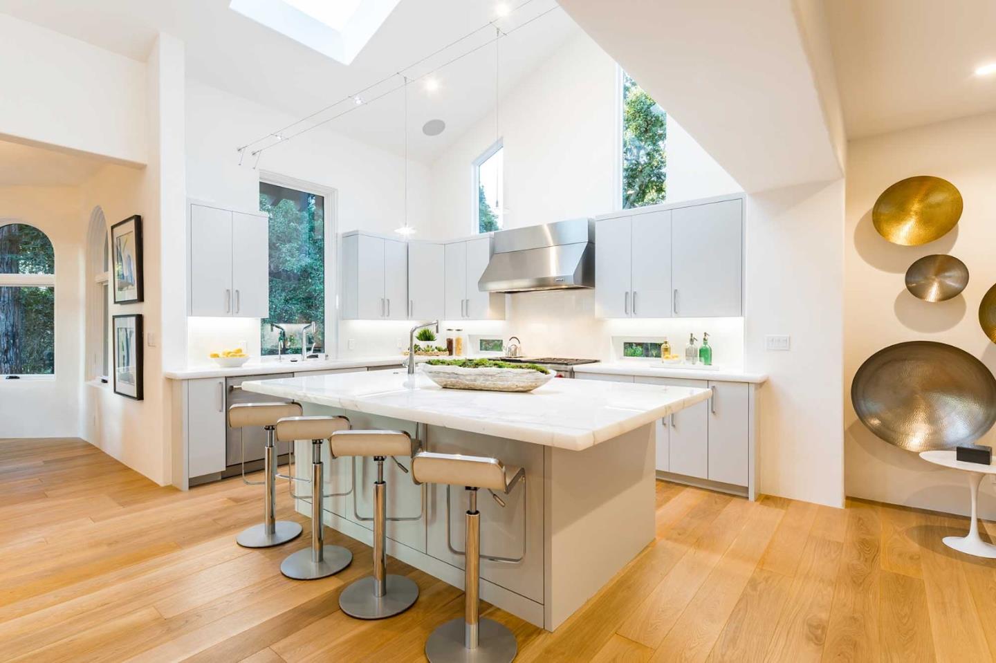 953 Roble Ridge Road Palo Alto, CA 94306 - Photo 16 of 50 a kitchen with kitchen island granite countertop wooden cabinets and counter space