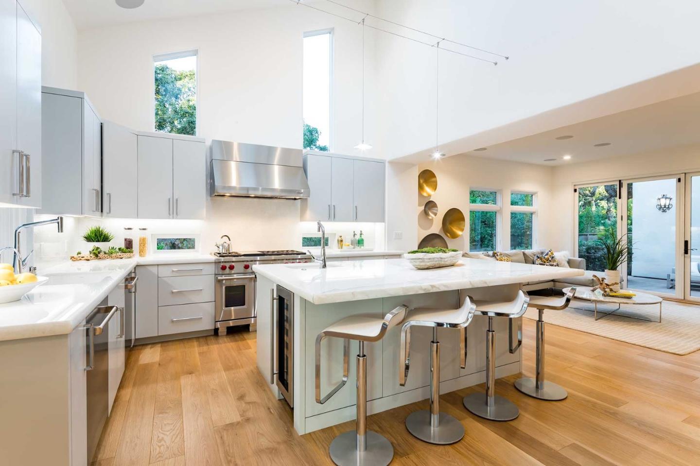 953 Roble Ridge Road Palo Alto, CA 94306 - Photo 18 of 50 a kitchen with a stove a sink dishwasher and a refrigerator with wooden floor