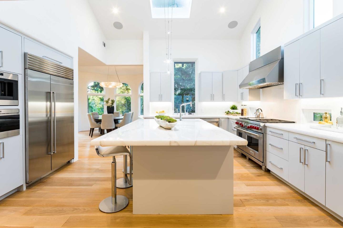 953 Roble Ridge Road Palo Alto, CA 94306 - Photo 19 of 50 a kitchen with stainless steel appliances granite countertop a sink a stove and a refrigerator