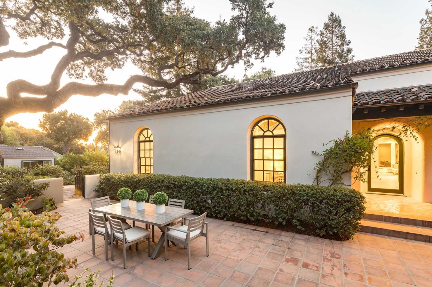 953 Roble Ridge Road Palo Alto, CA 94306 - Photo 3 of 50 a view of a patio with table and chairs and potted plants