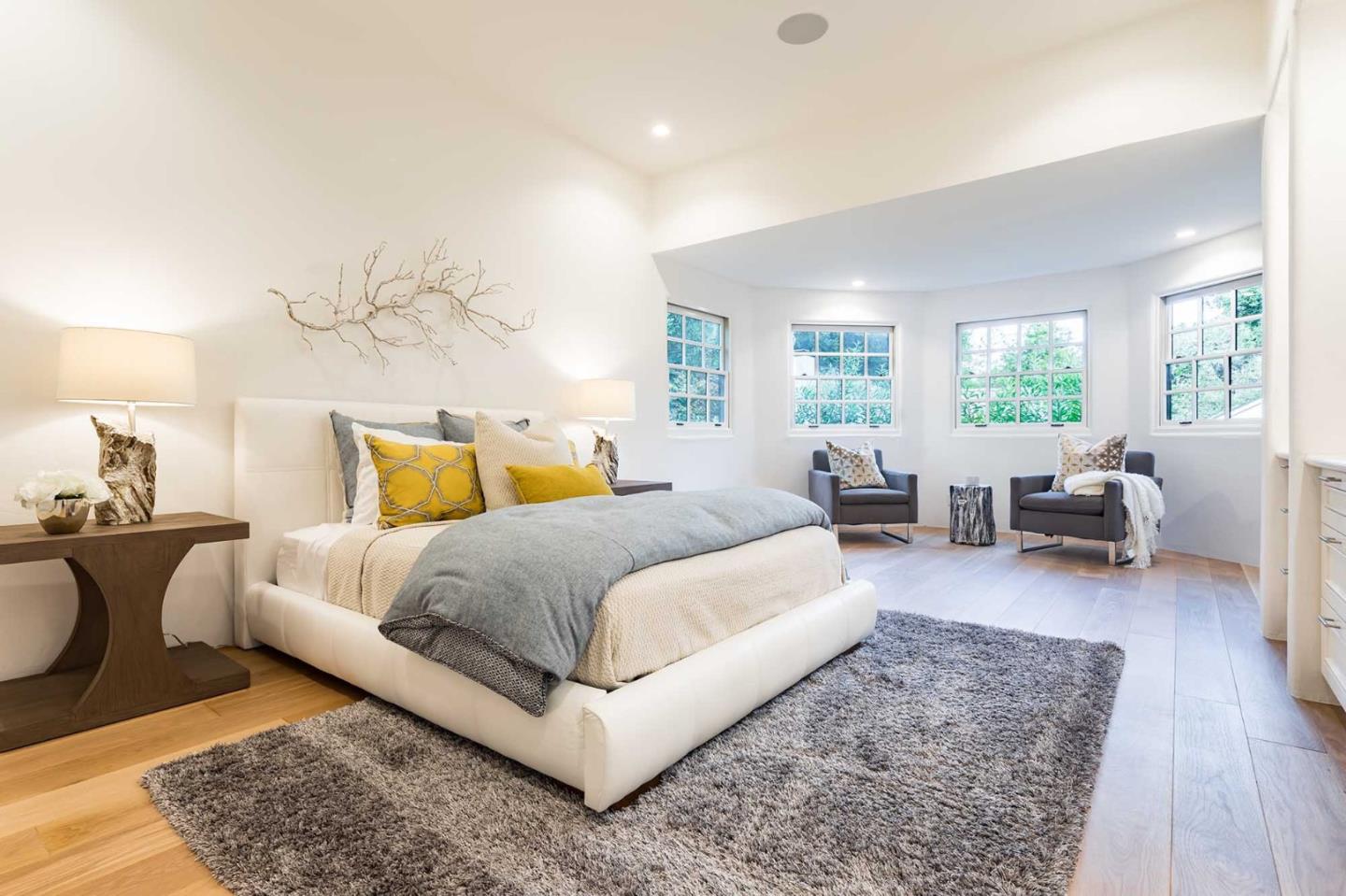 953 Roble Ridge Road Palo Alto, CA 94306 - Photo 40 of 50 a spacious bedroom with a bed a couch and large windows