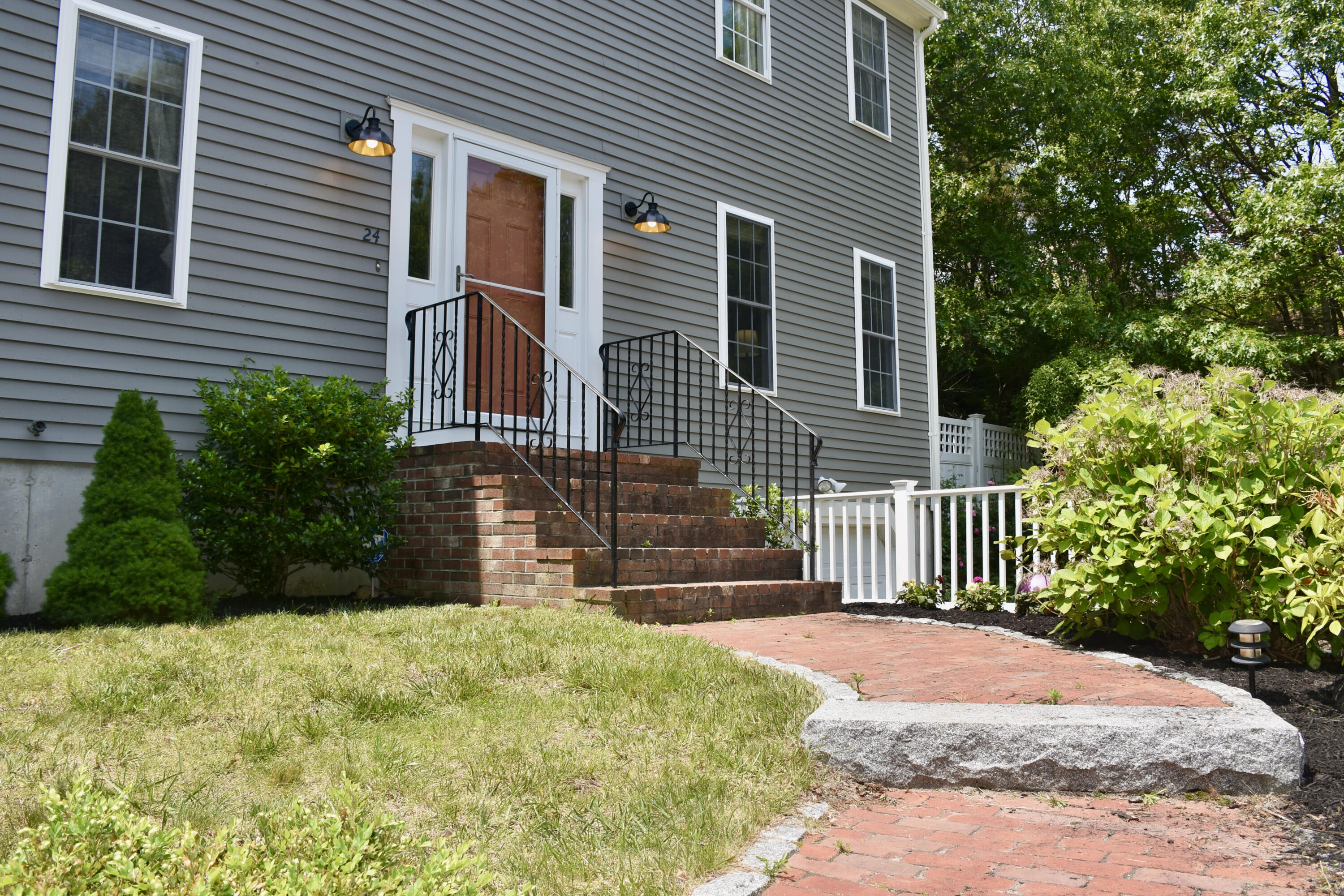 24 Sheppard Road Sagamore Beach, MA 02562 - Photo 3 of 41 a front view of a house with a garden