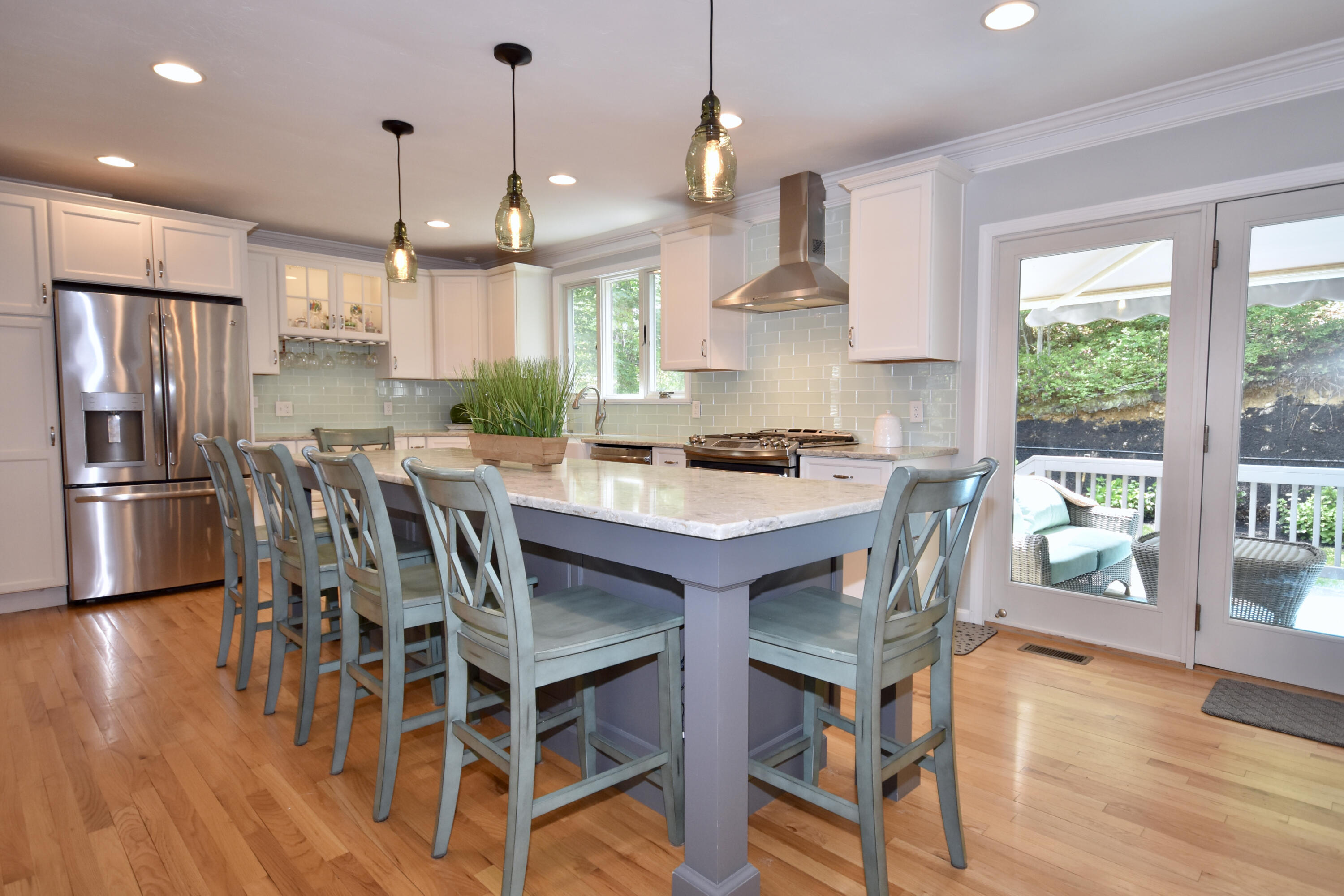 24 Sheppard Road Sagamore Beach, MA 02562 - Photo 9 of 41 a kitchen with stainless steel appliances a dining table chairs stove refrigerator and wooden floor