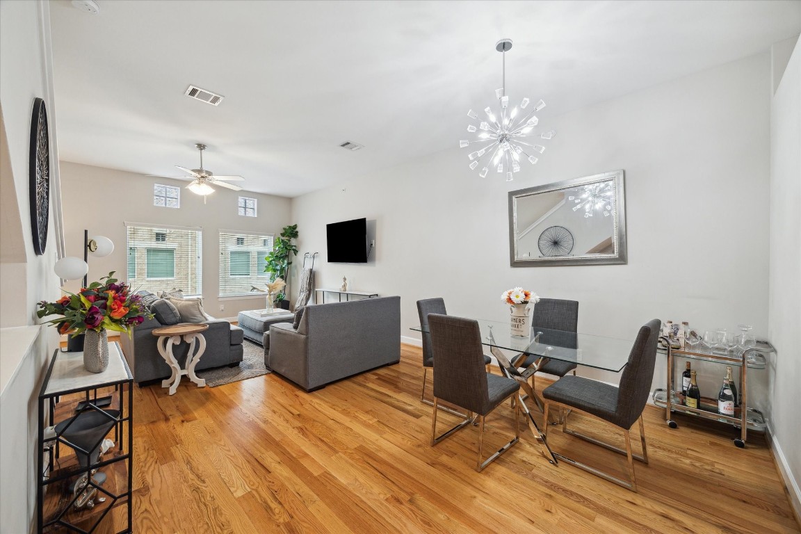 8705 Bryam Street, Unit 2003 Houston, TX 77061 - Photo 4 of 14 a view of a dining room with furniture wooden floor and chandelier