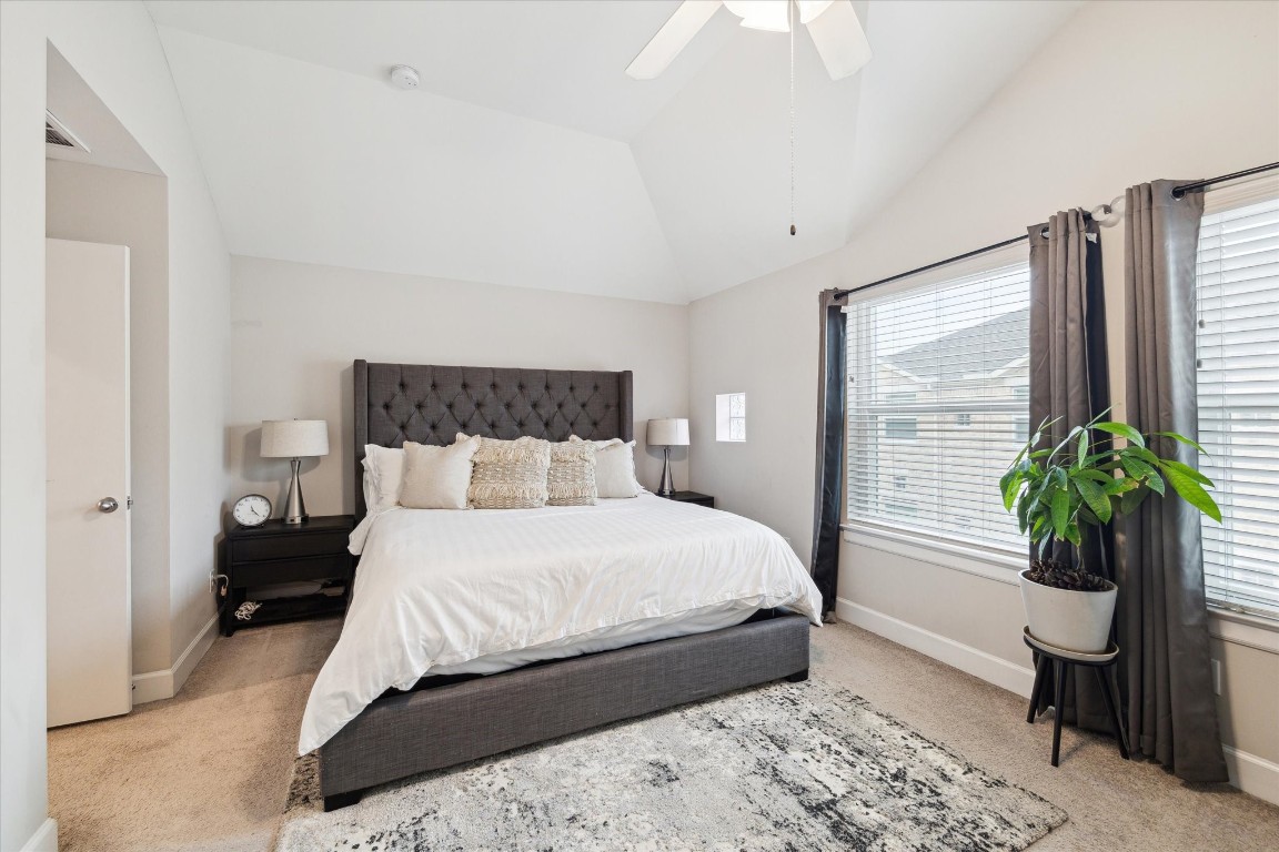 8705 Bryam Street, Unit 2003 Houston, TX 77061 - Photo 9 of 14 a bedroom with a large bed and a potted plant