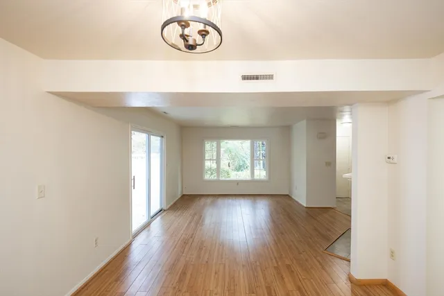 a view of a room with wooden floor