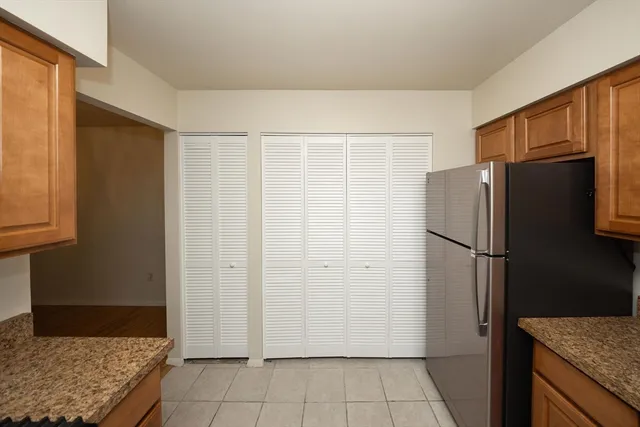 a view of a kitchen with refrigerator and cabinet