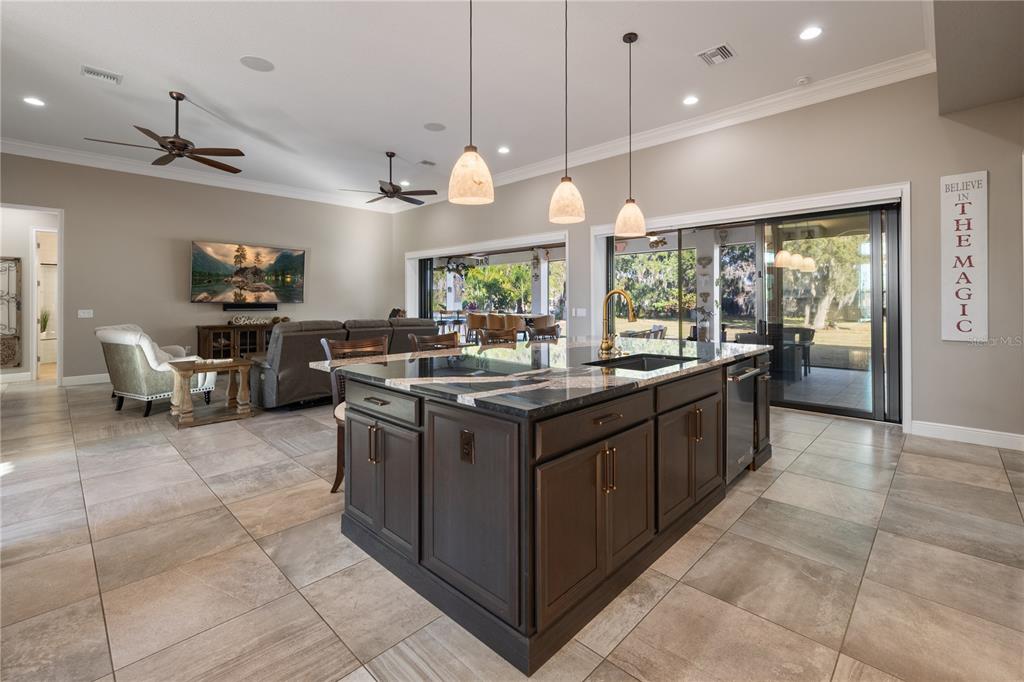 3738 Kissimmee Park Road St. Cloud, FL 34772 - Photo 22 of 62 a large kitchen with a large stove top oven a sink a counter space and living room view