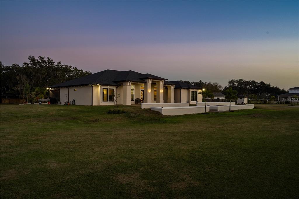 3738 Kissimmee Park Road St. Cloud, FL 34772 - Photo 3 of 62 a front view of a house with a garden