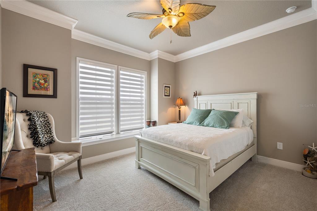 3738 Kissimmee Park Road St. Cloud, FL 34772 - Photo 39 of 62 a bedroom with a bed a chair and a chandelier