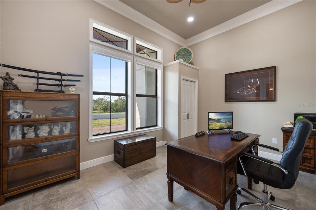 3738 Kissimmee Park Road St. Cloud, FL 34772 - Photo 7 of 62 a view of a workspace with furniture and a window
