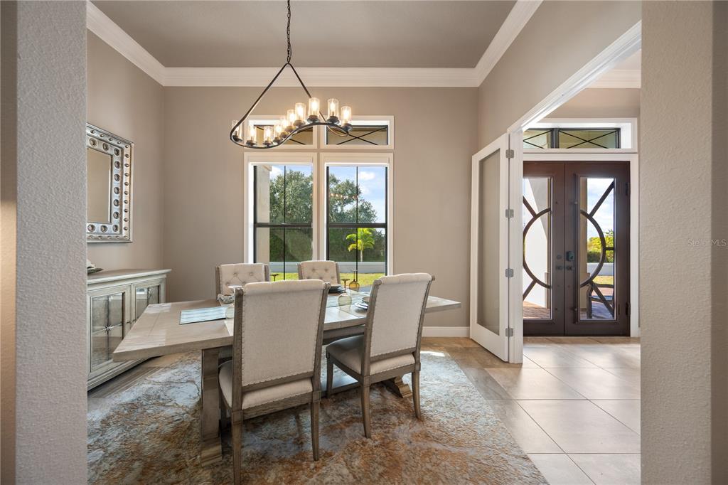 3738 Kissimmee Park Road St. Cloud, FL 34772 - Photo 9 of 62 a dining room with furniture a chandelier and window
