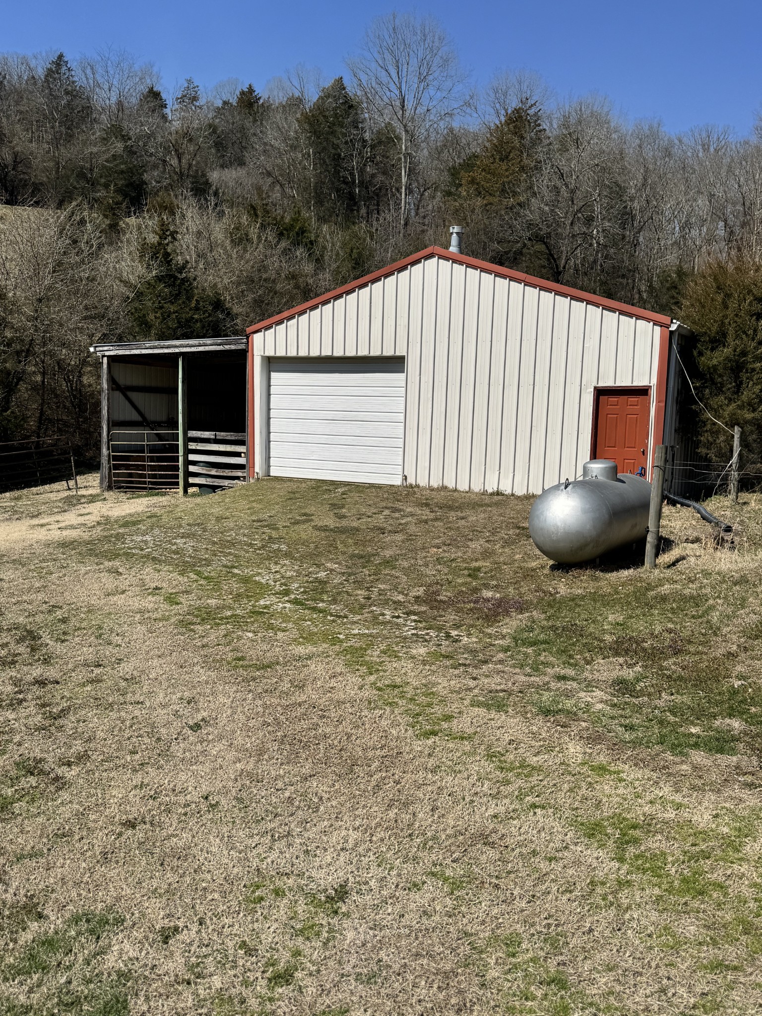 267 Difficult Road Pleasant Shade, TN 37145 - Photo 14 of 20 a backyard of a house with trees and barbeque oven
