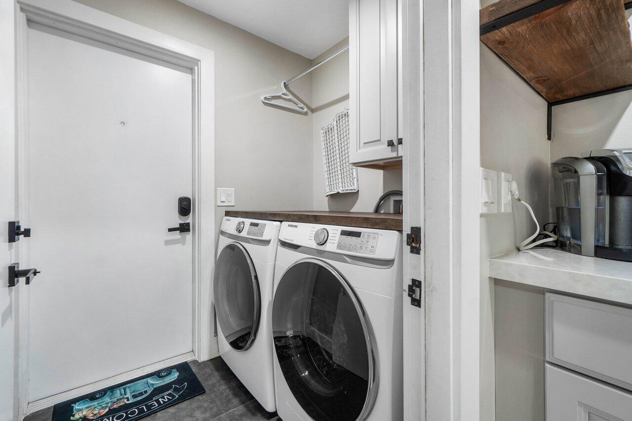 706 Sunset Road, Unit C West Palm Beach, FL 33401 - Photo 12 of 15 a view of a storage and utility room with closet dryer and washer