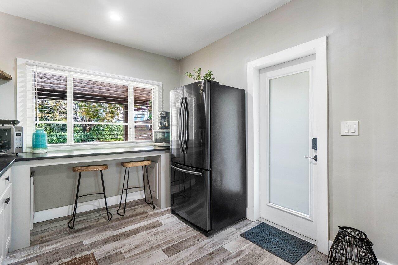 706 Sunset Road, Unit C West Palm Beach, FL 33401 - Photo 5 of 15 a kitchen with a refrigerator and window