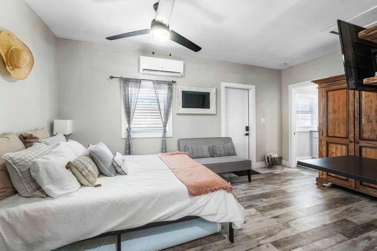 706 Sunset Road, Unit C West Palm Beach, FL 33401 - Photo 9 of 15 a bedroom with a bed and a chandelier