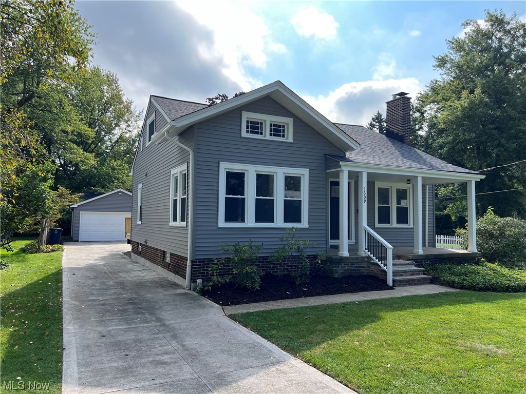 1609 Lyndhurst Road Lyndhurst, OH 44124 - Photo 2 of 34 View of front facade featuring garage and a front lawn