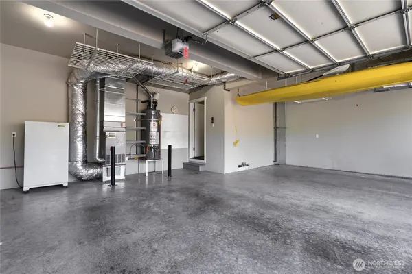 a view of an empty room with glass door and chandelier