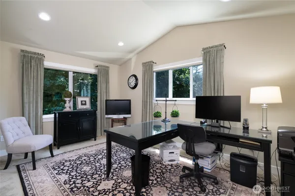 a living room with furniture a flat screen tv and a window