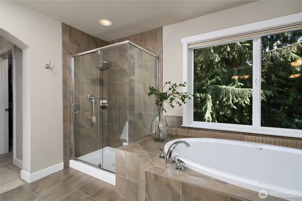 a bathroom with a tub and shower