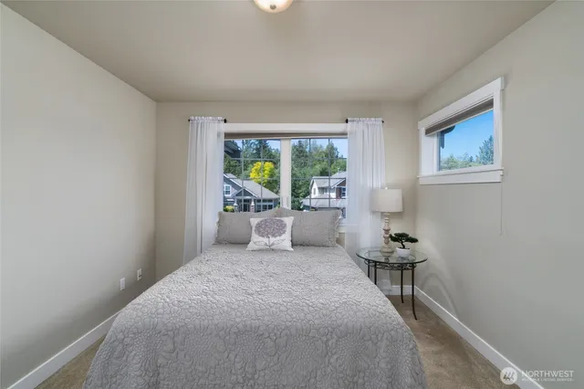 a bed room with a bed and a chair