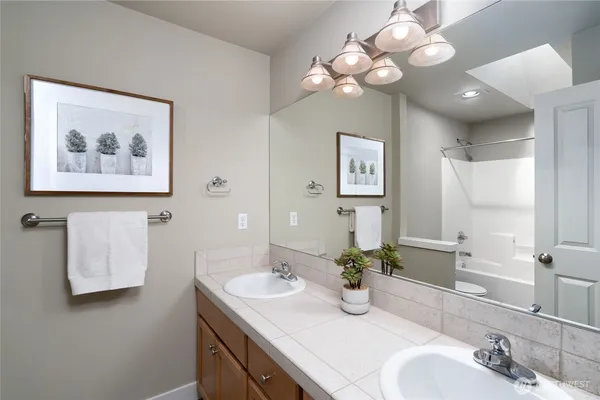 a bathroom with a sink vanity and a mirror