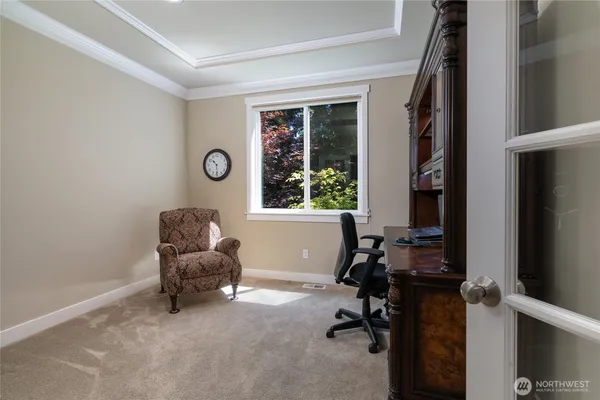 a livingroom with workspace and a window