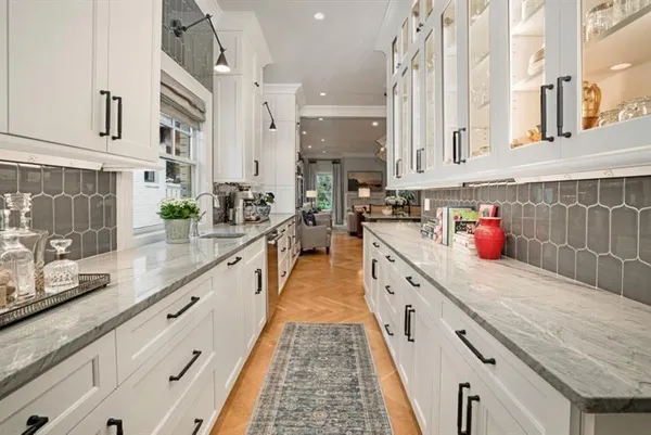 a kitchen with stainless steel appliances granite countertop lots of counter top space and wooden floor