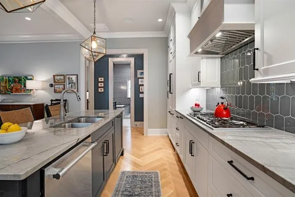 a kitchen with stainless steel appliances granite countertop a sink and stove