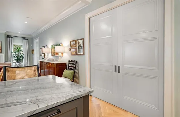 a kitchen with kitchen island sink refrigerator and fireplace