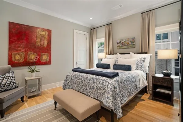 a bedroom with a bed and wooden floor