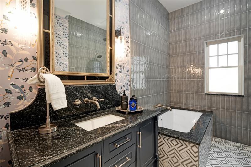 407 8th Street Northeast Atlanta, GA 30309 - Photo 23 of 34 a bathroom with a granite countertop sink a mirror and shower