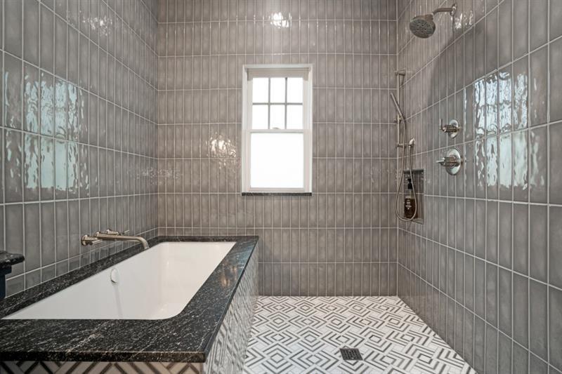 407 8th Street Northeast Atlanta, GA 30309 - Photo 24 of 34 a bathroom with a granite countertop bathtub and shower