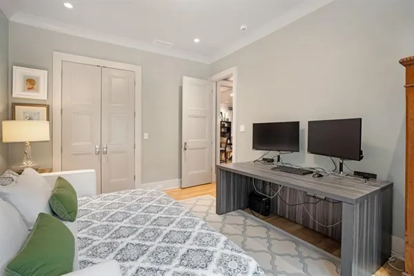 a bedroom with bed and a large window