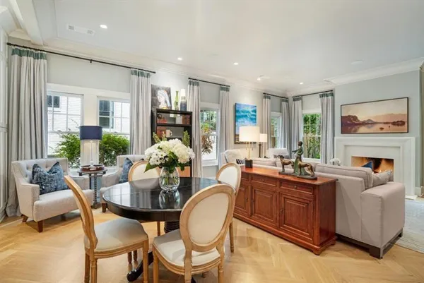 a living room with fireplace furniture and a large window