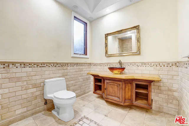 a spacious bathroom with a sink and a mirror