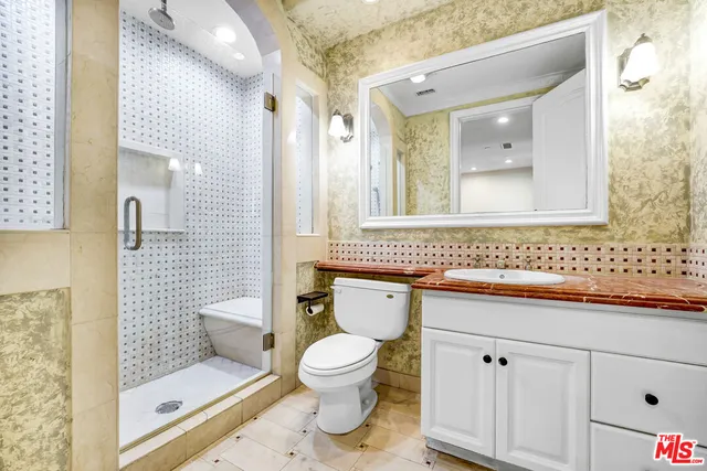 a bathroom with a toilet sink and shower