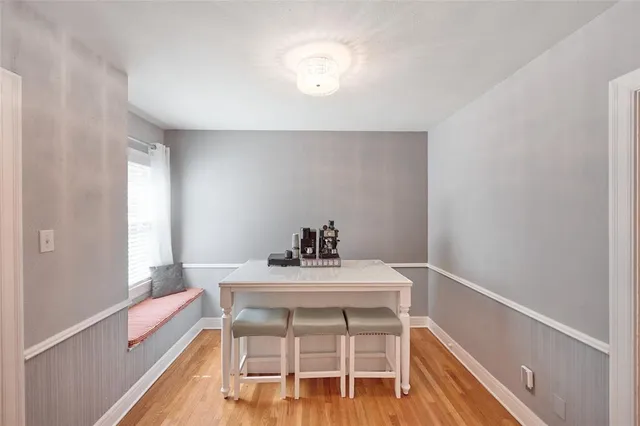 a view of a dining room with furniture and a window