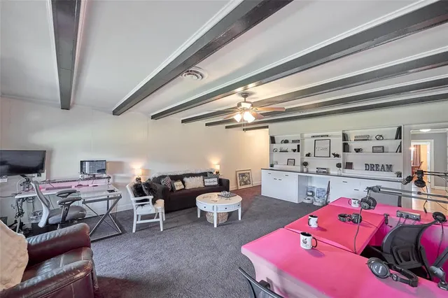 a living room with furniture a rug and white walls