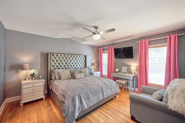 a bedroom with a bed couch and window