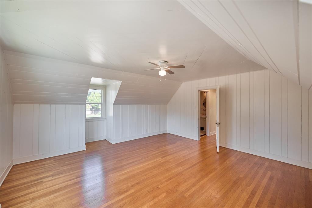 811 West Main Street Olney, TX 76374 - Photo 33 of 40 an empty room with wooden floor chandelier fan and windows