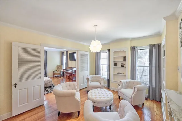 a living room with furniture a lamp and wooden floor