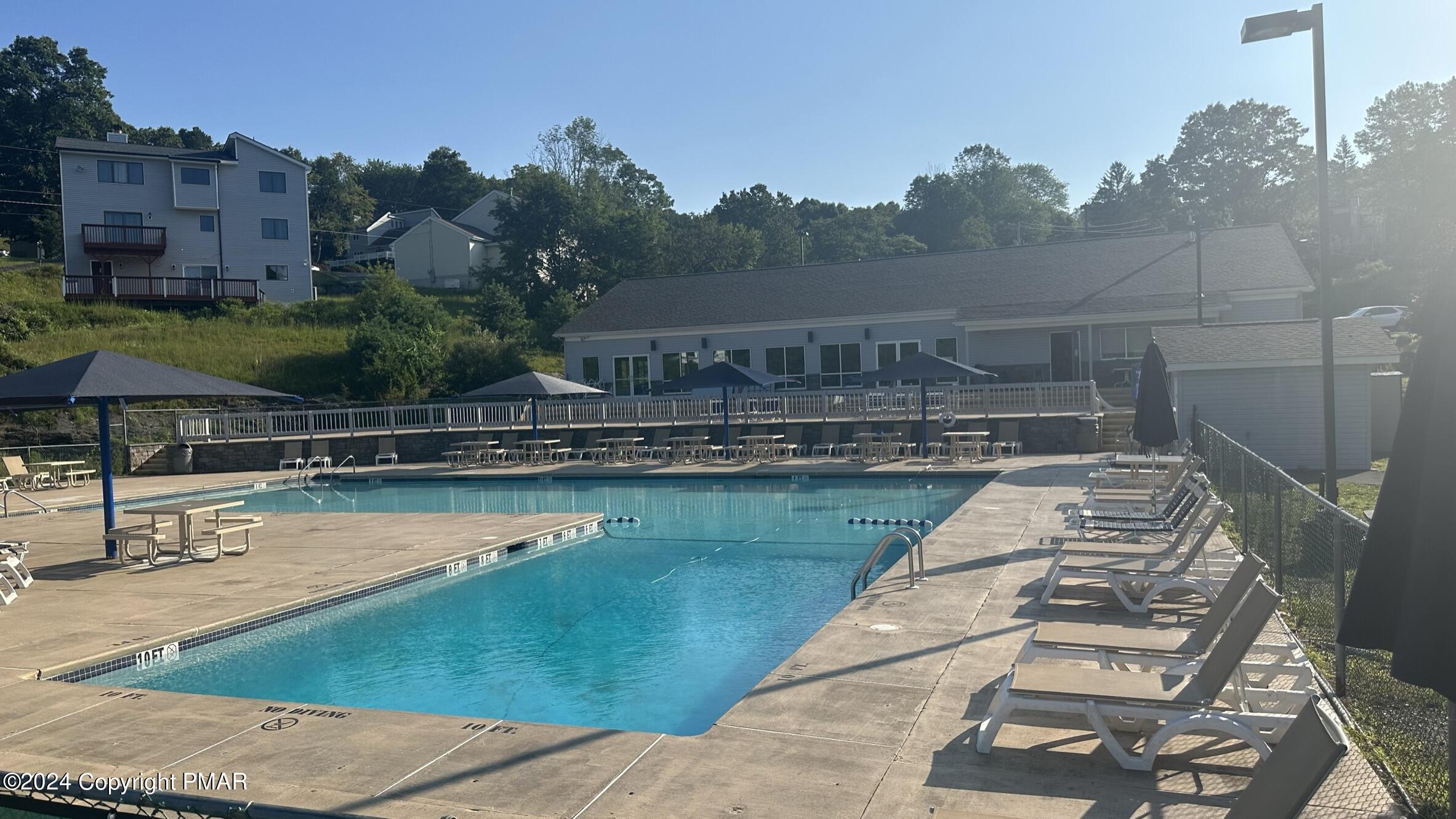 Lot 139 Berkshire Court Bushkill, PA 18324 - Photo 12 of 52 a view of swimming pool with outdoor seating and yard in the back