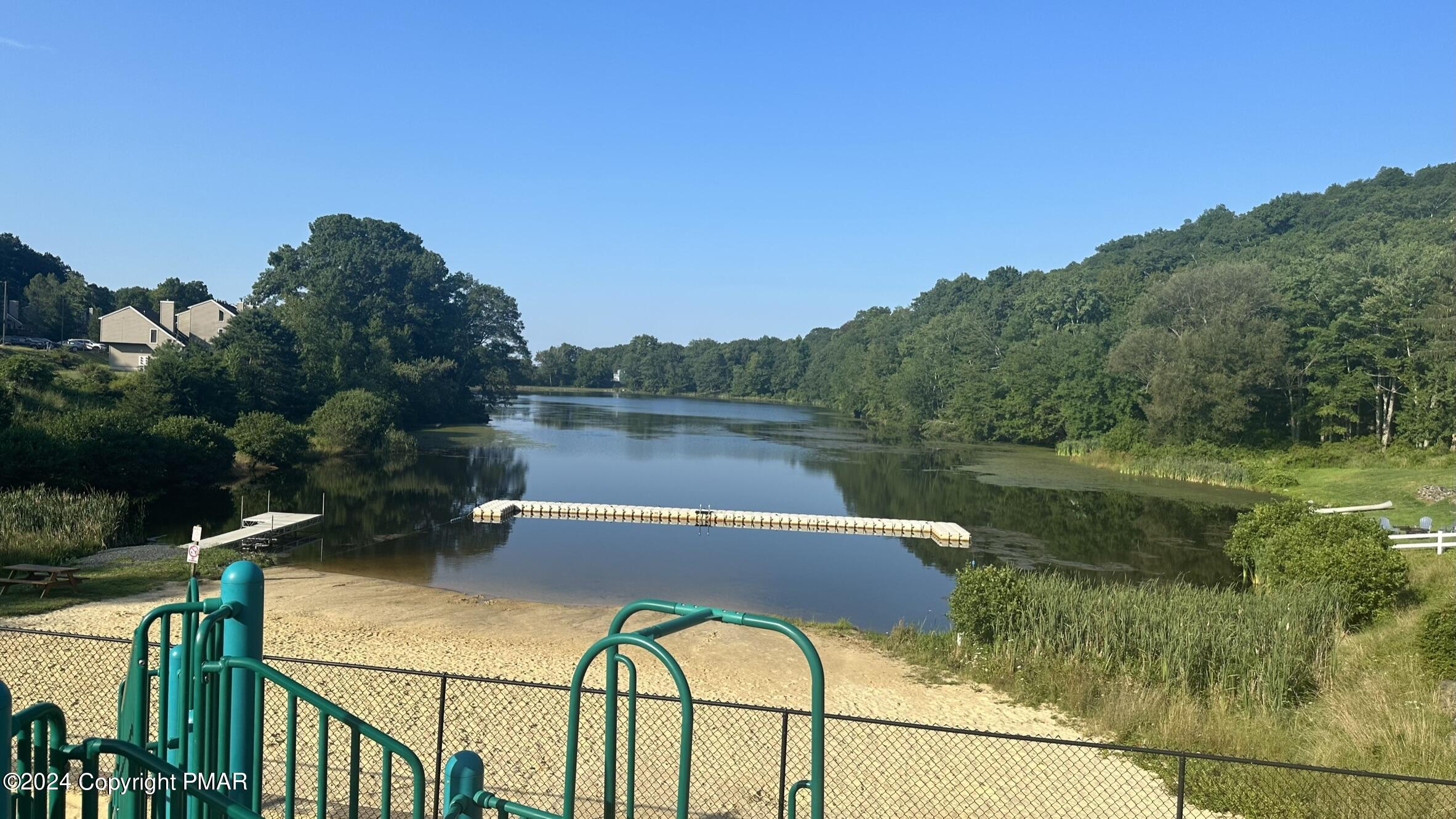 Lot 139 Berkshire Court Bushkill, PA 18324 - Photo 16 of 52 a view of a lake with a floor to ceiling window and outdoor seating