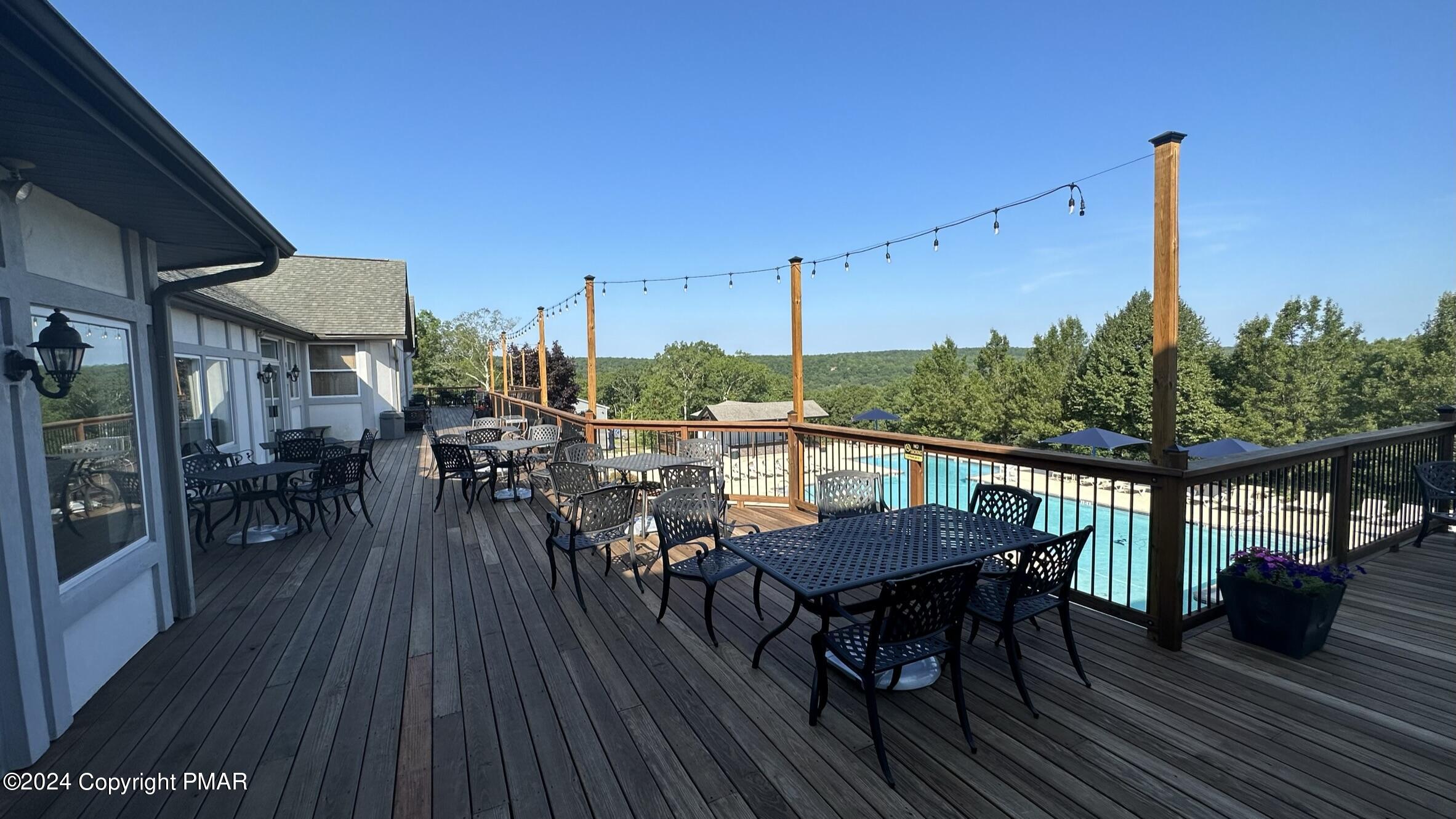 Lot 139 Berkshire Court Bushkill, PA 18324 - Photo 37 of 52 a view of a balcony dining table and chairs with wooden floor